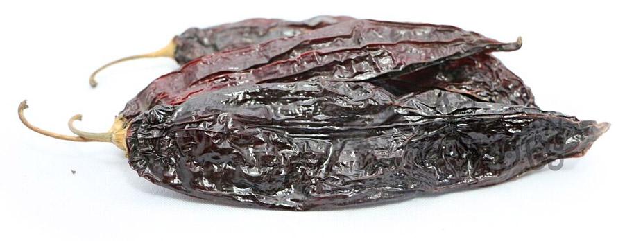 Whole dried Peruvian aji panca peppers with deep red-brown color